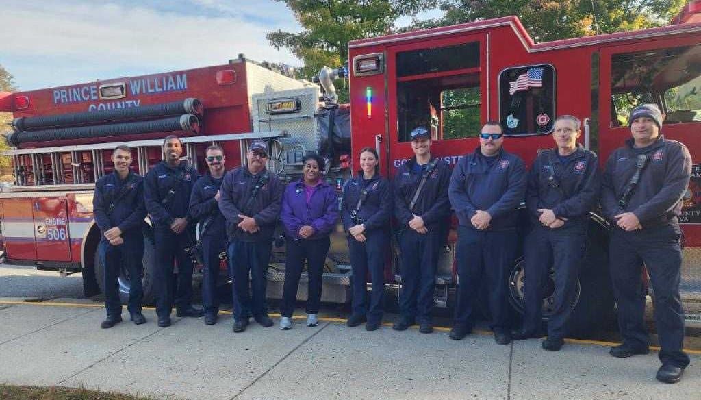 Kim Short with a Prince William County Fire and Rescue crew in front of Engine 506