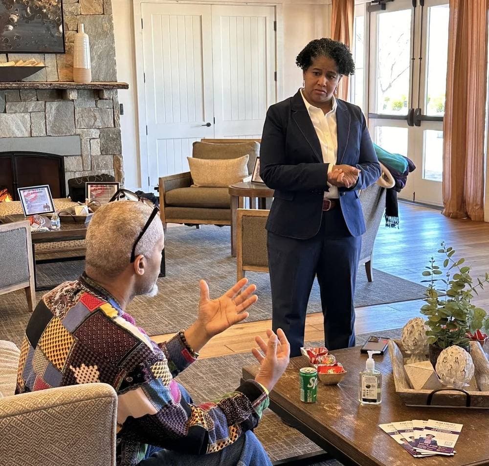 Kim Short listening to a resident at a community gathering in the Potomac District