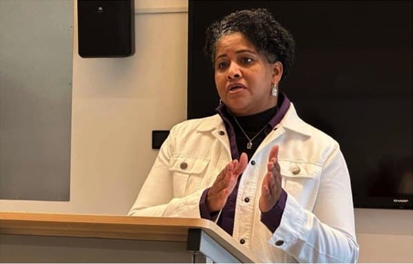 Kim Short speaking at a podium during a campaign event
