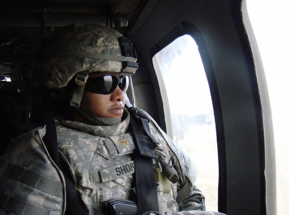 Kim Short in uniform aboard a helicopter during her deployment to Iraq